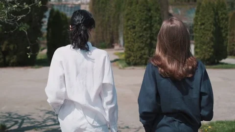 Two slender girlfriends in white and blue linen shorts. Video stock 151068313