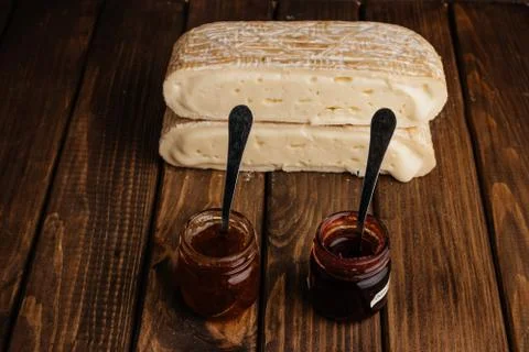 Two Slice of Crafted Brie Cheese with Honey on Wooden Brown Background with F 스톡 사진