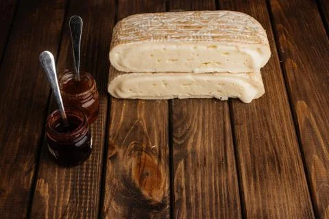 Two Slice of Crafted Brie Cheese with Honey on Wooden Brown Background with F 库存照片