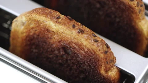 Two slice of roasted toast bread slices in toaster Stock Footage 140582357