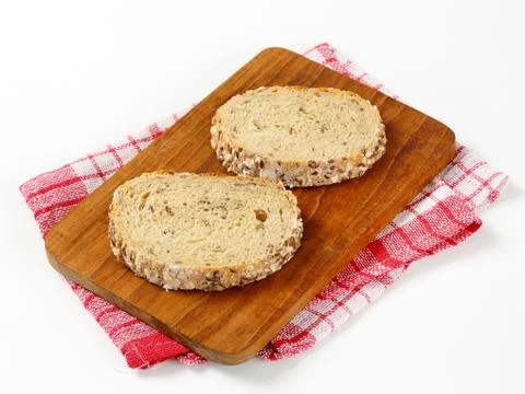 Two slices of bread on cutting board Stock Photos