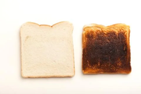 Two slices of bread, raw and burnt toast Stock Photos