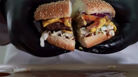 Two slices of delicious hamburger with beef Patty, melted cheese, lettuce and Stock Footage 132030637