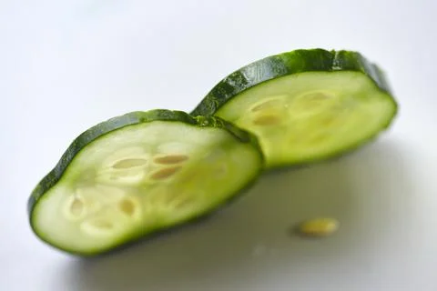 Two slices of fresh cucumber with backlit Stock Photos