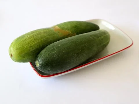 Two slices of fresh cucumber on a rectangular plate Stock Photos