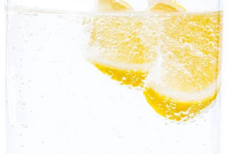 Two slices of fresh juicy lemon in lemonade. Stock Photos