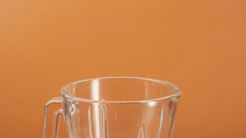 Two slices of fresh pineapple fall blender in slow motion Stock Footage 125295565