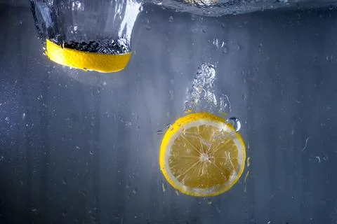 Two slices lemon falling water Stock Photos