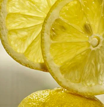Two slices of lemon fruit on the lemon peel at vertical close up Stock Photos