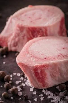 Two slices of marrowbone on dark board Stock Photos