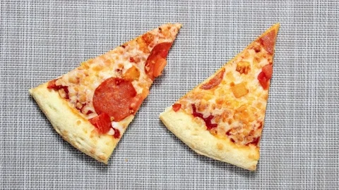 Two slices of pizza, which is gradually bitten off. Stock Footage 155904819