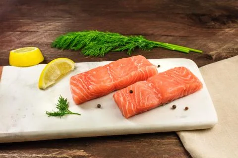 Two slices of salmon on dark background with copyspace 写真素材