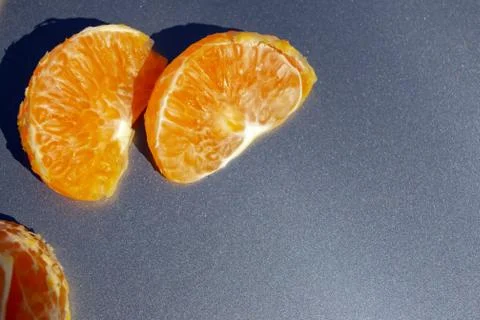 Two slices of tangerine on a gray background Stock Photos