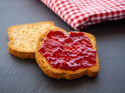 Two slices of toast with raspberry jam on a slate plate Two slices of toa... Stock Photos