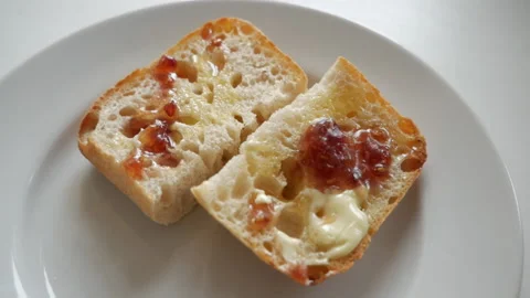 Two slices of white bread with butter and jam Stock-Footage 153436424