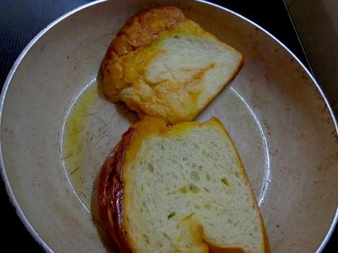 Two slices of white bread toasted on a griddle Foto stock