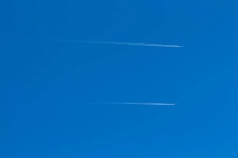 Two small aircraft flying parallel and reverse trace of them Stock Photos