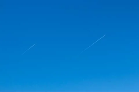 Two small aircraft flying parallel and reverse trace of them Stock Photos