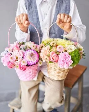 Two Small Beautiful bouquets of mixed flowers in woman hand. Floral shop concept Stock Photos