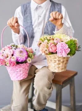Two Small Beautiful bouquets of mixed flowers in woman hand. Floral shop concept Stock Photos