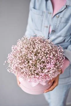 Two Small Beautiful bouquets of mixed flowers in woman hand. Floral shop concept Stock Photos