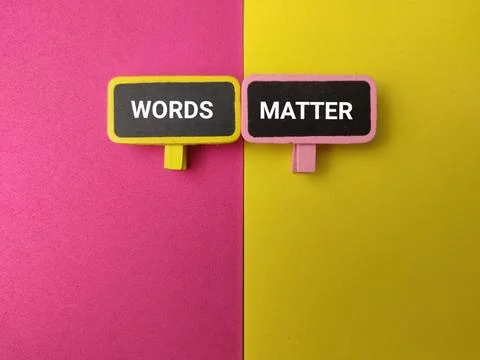 Two small blackboards reading WORDS and MATTER clip onto a dual pink and ye.. Stock Photos