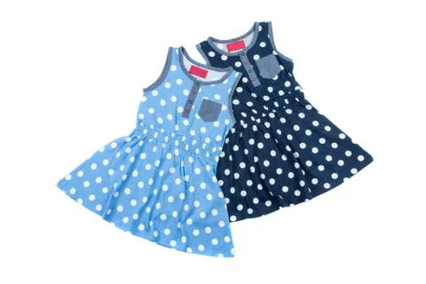 Two small blue polka dot dress for girls, isolated on white background Stock Photos