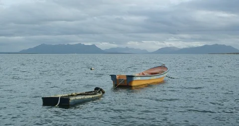 Two small boats docked in mountain lake Stock Footage 90074686