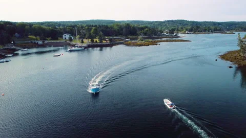 Two small boats pass one another in the narrows of Glen Margaret Bay Stock Footage 284684871