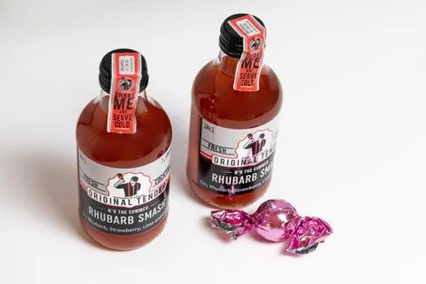 Two small bottles of gin. Pink fruity Original Tender Gin. Stock Photos