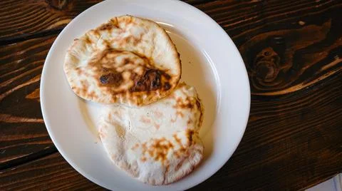 Two small bread tortillas stand in a plate on the table Stock Photos