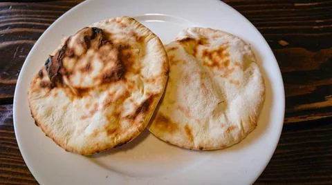 Two small bread tortillas stand in a plate on the table Stock Photos
