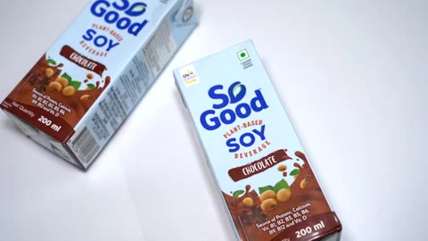 Two small cartons of So Good chocolate soy milk. Vídeo Stock 314390387
