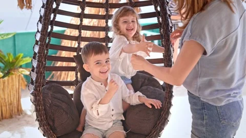Two small children and their mother are having fun playing game, showing symbols Stock Footage 282192162