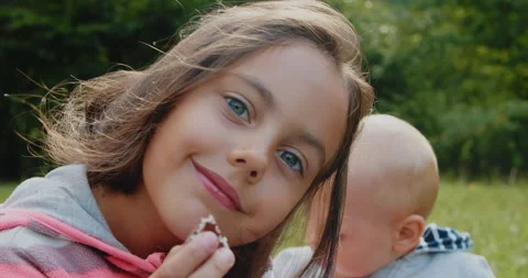 Two small children eat sweets in nature. Video stock 217423338