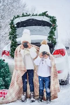 Two small children in the winter forest Stock-Fotos