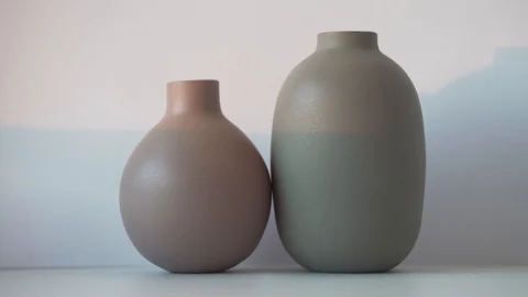Two small clay vases stand next to each other Stock Footage 121314051