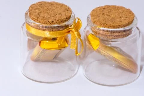 Two small closed glass jars with the sweets inside Stock Photos