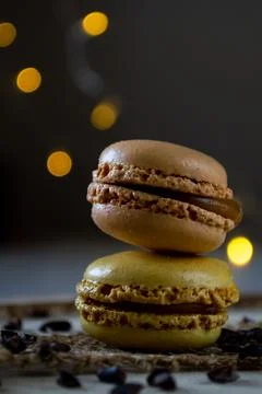 Two small colored macaroons on a dark background Stock Photos