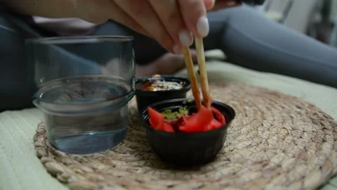 Two small containers filled with soy sauce, pickled ginger and wasabi Stock-Footage 347155504