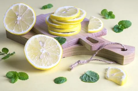 Two small cutting boards with slices of ripe fresh lemon Stock Photos
