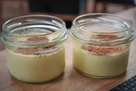 Two small dessert jars presented side by side with creamy filling Stock Photos