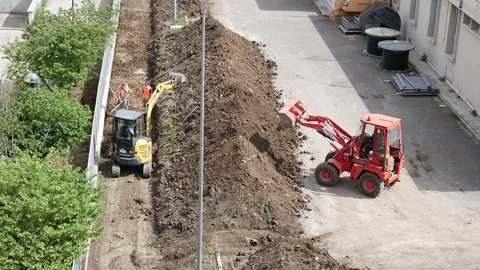Two small excavators at work on a construction site Video stock 242948059
