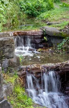 Two small flowing waterfalls Stock Photos