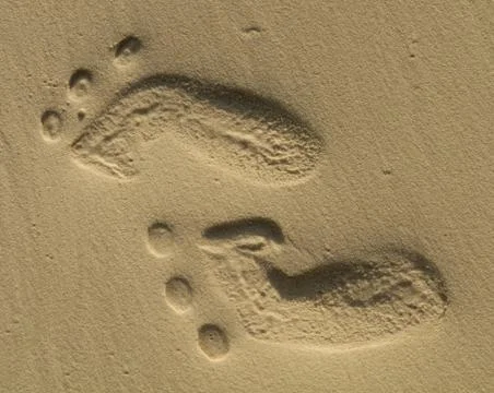 Two small footprints on sand Stock Photos