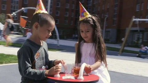 Two small friend wearing b-day cap celebration something 스톡 동영상 79870123