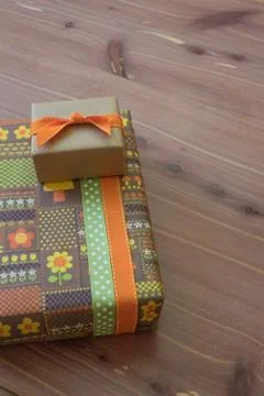 Two small gift boxes in green orange and brown with ribbons, retro style Stock Photos