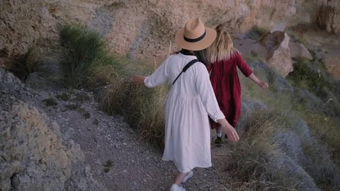 Two small girls walk in rocks Stock Footage