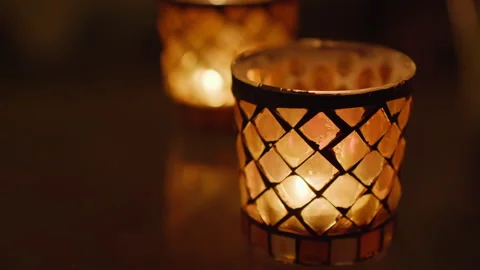 Two small glass candlesticks with a diamond pattern with flickering flames Stock Footage 269228640