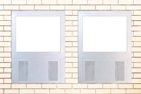 Two small led displays with empty frame on brick wall Stock Photos